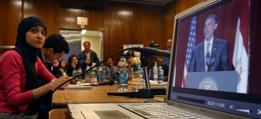 aiza Ali, Council on American-Islamic Relations (CAIR) community affairs director, watches U.S. President Barack Obama's speech from Cairo projected on a big screen off a laptop computer with New York area Muslim leaders at the InterChurch Center in New Y