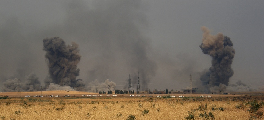 Smoke rises during a military operation launched by Kurdish troops known as peshmerga to regain control of some villages from Islamic State group west of the oil-rich city of Kirkuk, 180 miles (290 kilometers) north of Baghdad, Iraq, Sept. 30, 2015.