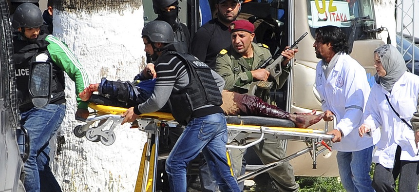 A victim is evacuated by rescue workers outside the Bardo museum in Tunis, Tunisia, on March 18, 2015.