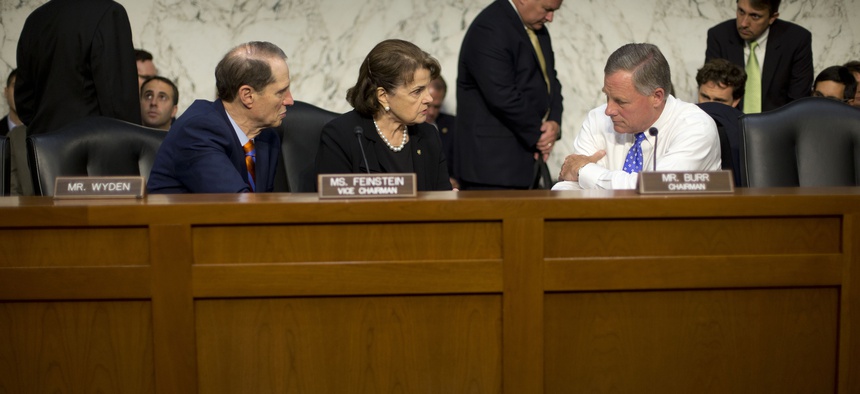 Senate Intelligence Committee Chairman Sen. Richard Burr, R-N.C., right, confers with committee Vice-Chair. Sen. Dianne Feinstein, D-Calif., center, and committee member Sen. Ron Wyden, D-Ore., on Capitol Hill, Thursday, Sept. 24, 2015.