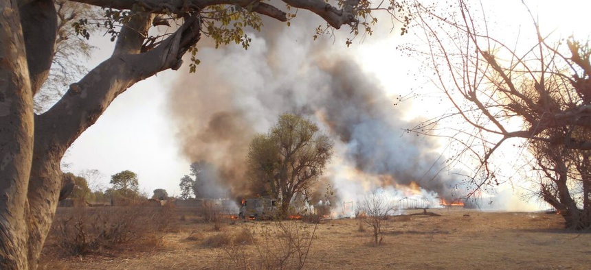 In this photo made available by the Nigerian Military taken Tuesday, April 28, 2015, an Islamic extremist camp burns after it was allegedly destroyed by Nigerian military personnel during a attack on Islamic extremists positions in the Sambisa Forest, Nig