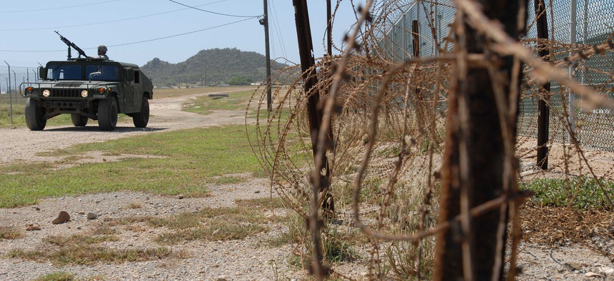 A Humvee from the Puerto Rico Army National Guard's, 480th Military Police Company, patrols the perimeter of the detention facility at Guantanamo Bay Naval Base, Cuba.