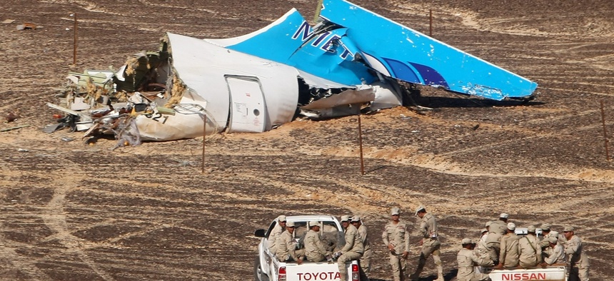 Egyptian Military on cars approach a plane's tail at the wreckage of a passenger jet bound for St. Petersburg in Russia that crashed in Hassana, Egypt, on Sunday, Nov. 1, 2015.