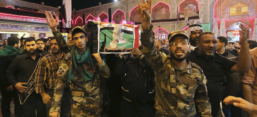 Iraqi fighters of the Peace Brigades, a Shiite militia group loyal to cleric Muqtada al-Sadr, angry after two of their members were killed in Ramadi during fighting with Islamic State militants, Nov. 7, 2015.