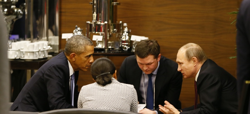 U.S. President Barack Obama, left, speaks with Russian President Vladimir Putin, right prior to the opening session of the G-20 summit in Antalya, Turkey, Sunday, Nov. 15 2015.