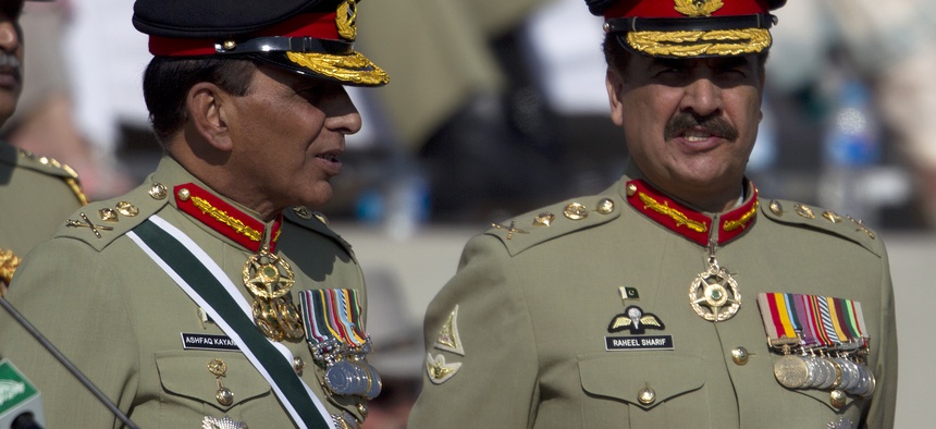 Pakistan's outgoing army chief Gen. Ashfaq Kayani, left, talks with his successor Gen. Raheel Sharif at a command changing ceremony in Rawalpindi, Pakistan, Friday, Nov. 29, 2013.