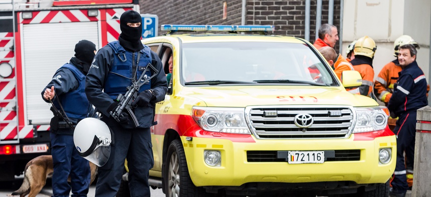 Armed police guard a street in Brussels on Monday, Nov. 16, 2015.
