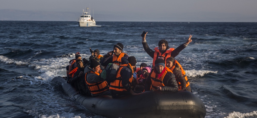 Refugees and migrants arrive safely on a dinghy from the Turkish coast to the northeastern Greek island of Lesbos on Tuesday, Nov. 17, 2015.