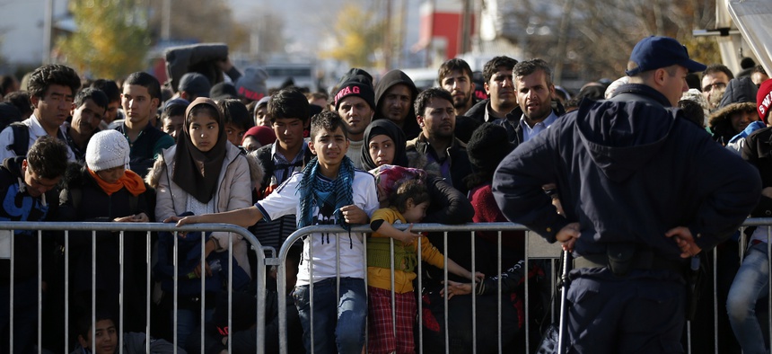 Migrants wait to register with the police at the refugee center in the southern Serbian town of Presevo, Monday, Nov. 16, 2015.