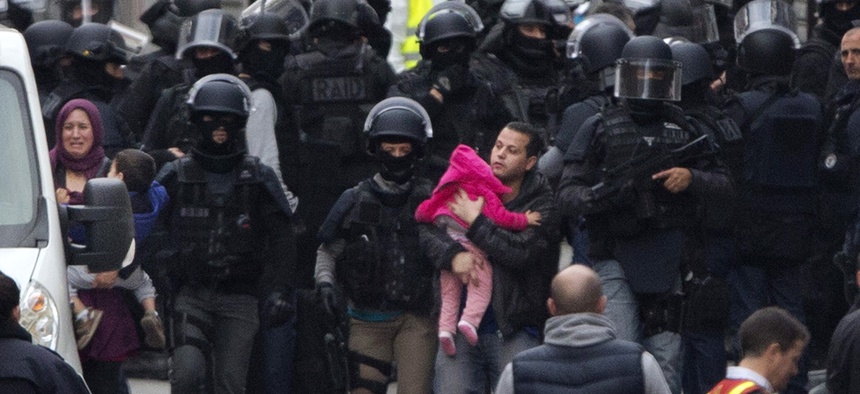 Residents are evacuated in Saint Denis, near Paris, Wednesday, Nov. 18, 2015. A woman wearing an explosive suicide vest blew herself up Wednesday.