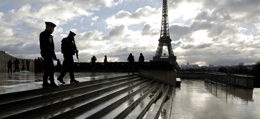 French soldiers patrol the Trocadero place near the Eiffel Tower, in Paris, Saturday, Nov. 21, 2015.