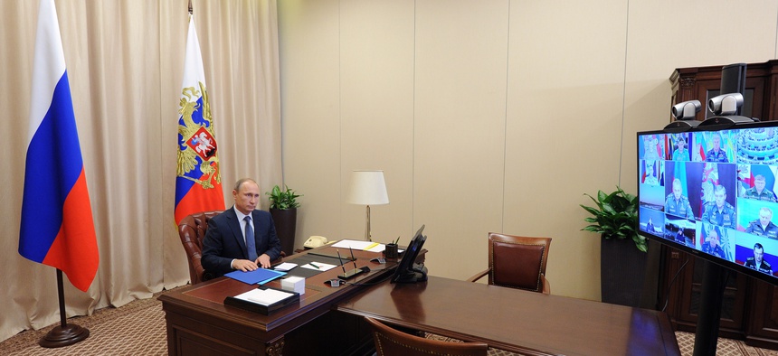 Russian President Vladimir Putin holds a video conference with the top military brass on a Russian air campaign in Syria, in the Novo-Ogaryovo residence outside Moscow, Russia, Friday, Nov. 20, 2015.