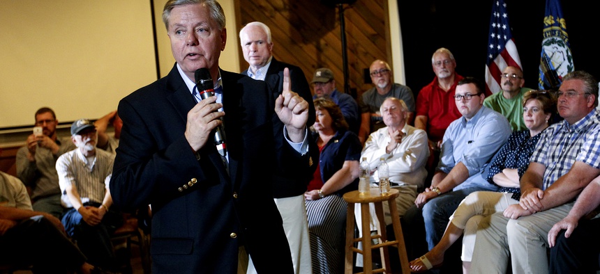 Republican presidential candidate Sen. Lindsey Graham (R-S.C.), front center, campaigns with Sen. John McCain, R- Ariz, back center, as they hold a town hall meeting in Manchester, N.H., Saturday, Aug. 1, 2015.