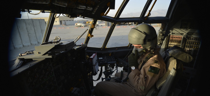 U.S. Air Force Capt. Frank Von Heiland, 41st Expeditionary Electronic Combat Squadron co-pilot, checks his oxygen mask on an EC-130H Compass Call aircraft at Bagram Air Field, Afghanistan, Sept. 12, 2014.