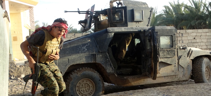 Iraqi security forces take combat positions at the front-line with Islamic State group militants as Iraqi Army and allied Sunni volunteer tribal fighters supported by U.S.-led coalition airstrikes on Ramadi, the capital of Iraq's Anbar province, 70 miles