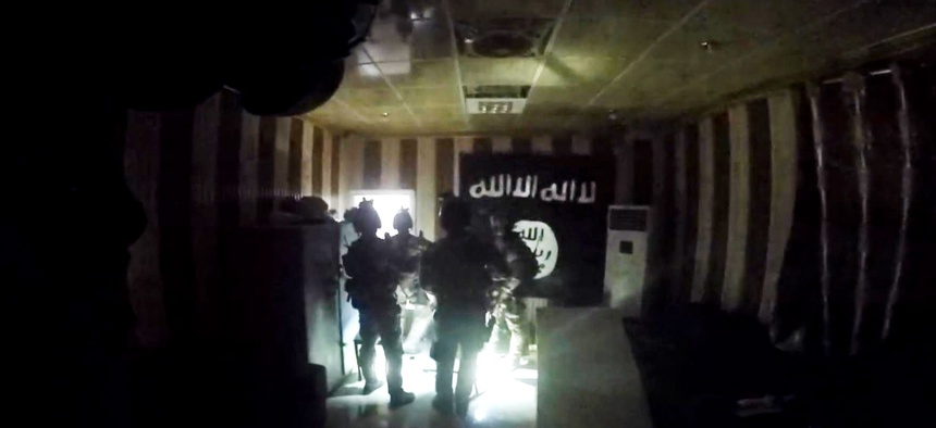 U.S. and Iraqi special forces search for enemy fighters and free dozens of hostages from a makeshift prison in Huwija, Iraq, in this image from helmet cam video taken Oct. 22, 2015.