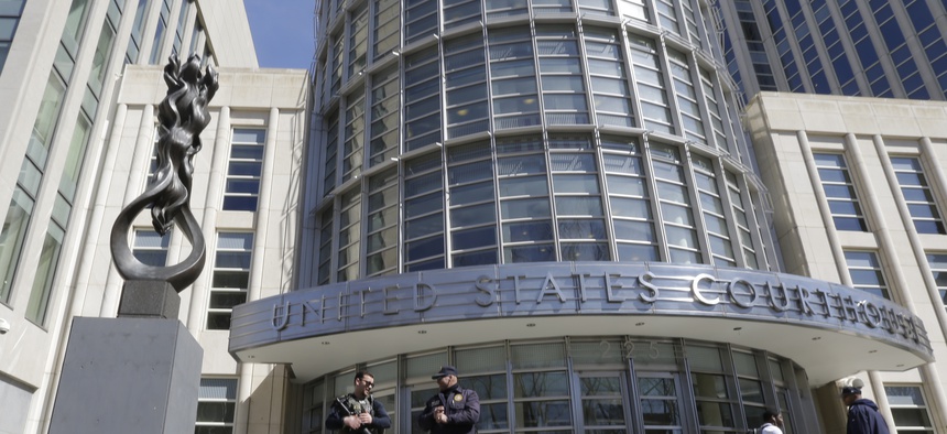Heavily armed U.S. Marshals stand guard outside federal court Thursday, April 2, 2015, in the Brooklyn borough of New York.