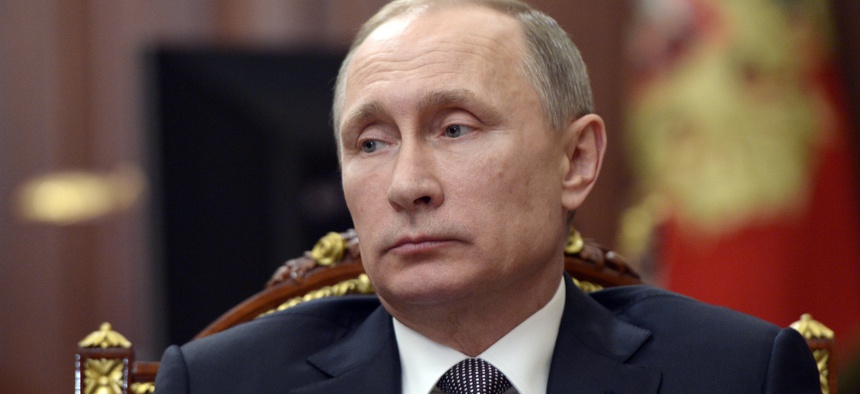 Russian President Vladimir Putin listens to explanations of Director of the Kurchatov nuclear and scientific research institute Mikhail Kovalchuk in Moscow's Kremlin, Russia, Monday, Dec. 7, 2015.