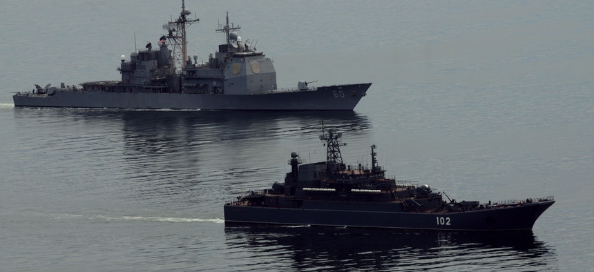 Happier times: The guided-missile cruiser USS Normandy (CG 60), left, and the Russian amphibious ship RFS Kaliningrad (LSTM 102) conduct anti-piracy training during the Baltic Operations (BALTOPS) 2012 exercise.