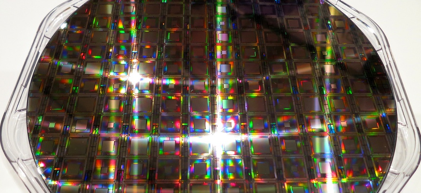 A quantum computing chip at the 2014 In-Q-Tel CEO Summit .