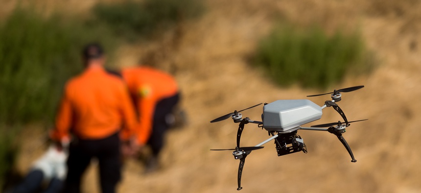 A drone flies over a ravine as the Alameda County Sheriff's Office demonstrates a search and rescue operation, Friday, Aug. 14, 2015, in Dublin, Calif.