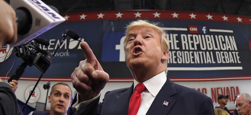 Donald Trump talks to the press in the spin room following the CNN Republican presidential debate at the Venetian Hotel & Casino on Tuesday, Dec. 15, 2015, in Las Vegas.