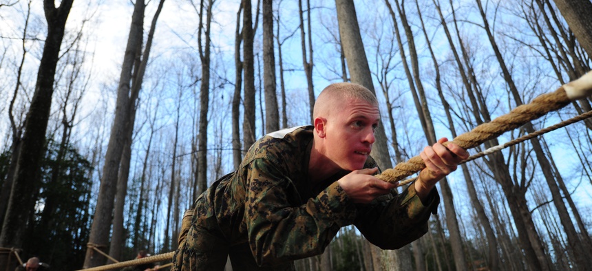 A Marine Officer Candidates School troop maneuvers down a horizontal rope on Dec. 9, 2011, at Marine Corps Base Quantico, Va.