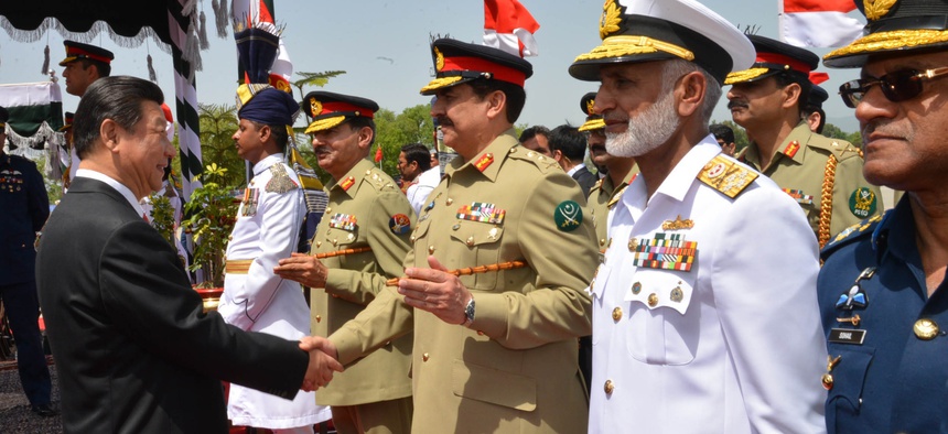In this April 20, 2015, file photo provided by Pakistan's Press Information Department, Chinese President Xi Jinping, left, shakes hands with Pakistan's army chief Gen. Raheel Sharif, at Nur Khan airbase in Islamabad, Pakistan.