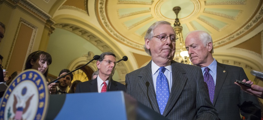 Senate Majority Leader Mitch McConnell, R-Ky., center, joined at right by Majority Whip John Cornyn, R-Texas, and at rear left by Sen. John Barrasso, R-Wyo., at the Capitol in Washington, Jan. 20, 2016.