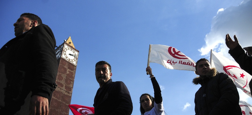 Unemployed tunisian people stage a protest in a precarious calm enforced by a nationwide curfew in Habib Bourguiba avenue, center downtown of Tunis, Saturday Jan. 23, 2016.