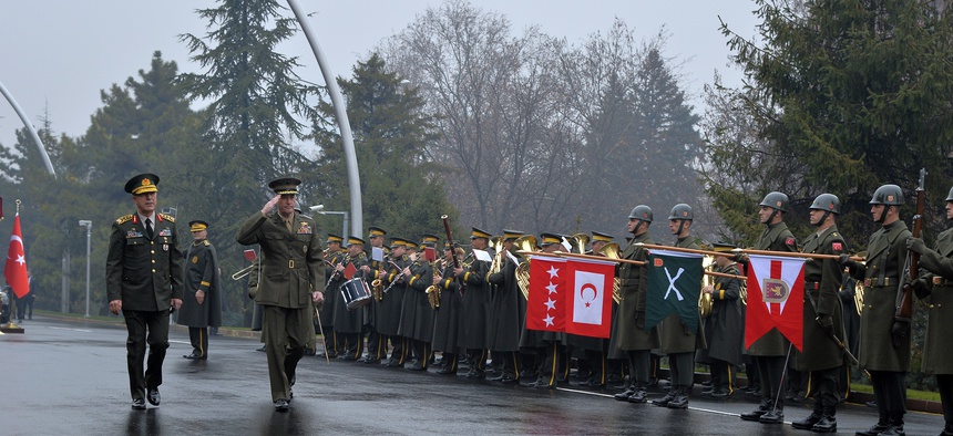 Chairman of the U.S. Joint Chiefs of Staff, Gen. Joseph Dunford, second left, and Turkey's Chief of Staff Gen. Hulusi Akar inspect a military honour guard in Ankara, Turkey, on Jan. 6, 2016.