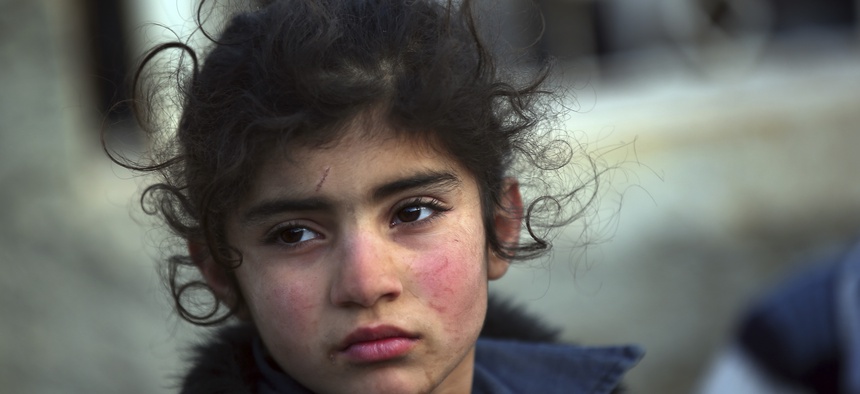 A Syrian child and thousands of others are arriving at the Bab al-Salam border crossing with Turkey, Feb. 6, 2016.