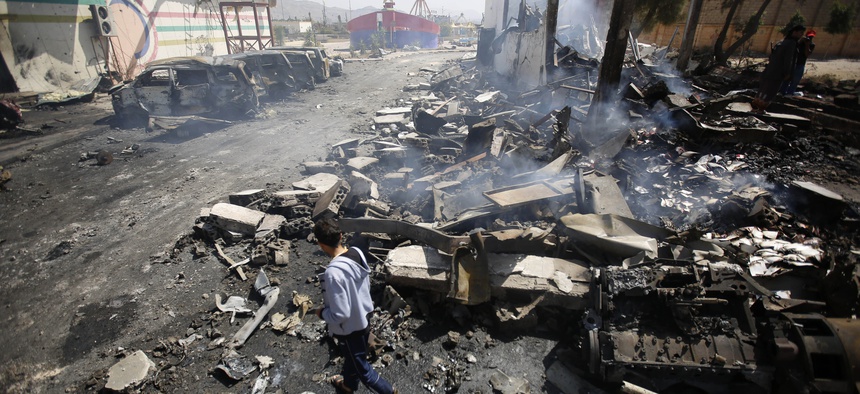 A Yemeni man inspects the site of Saudi-led airstrikes in Sanaa, Yemen, Friday, Feb. 12, 2016.
