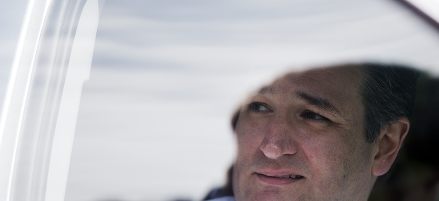 Republican presidential candidate Sen. Ted Cruz, R-Texas, speaks with his aide from a vehicle Sunday, Feb. 14, 2016, after attending services at Community Bible Church in Beaufort, S.C.