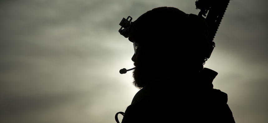A U.S. Marine special operator assists with security during a construction project for an Afghan Local Police (ALP) checkpoint in Helmand province, Afghanistan, March 30, 2013.