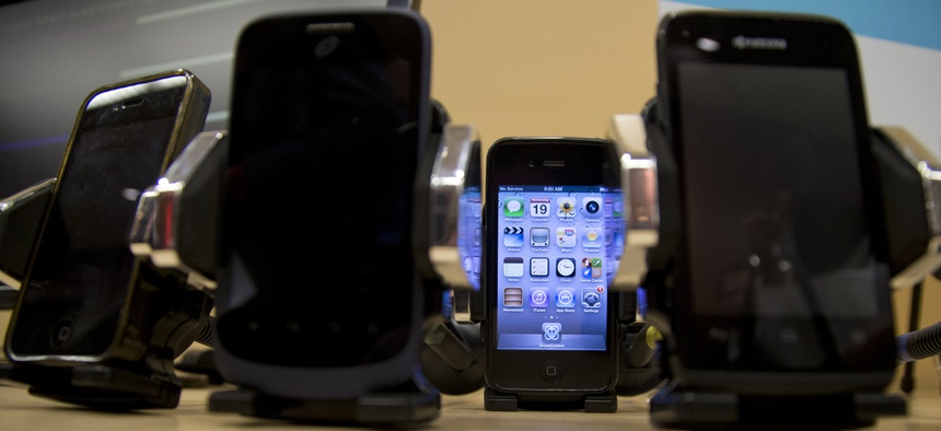 Cell phones are displayed during a Federal Trade Commission (FTC) mobile tracking demo, Wednesday, Feb. 19, 2014, in Washington.