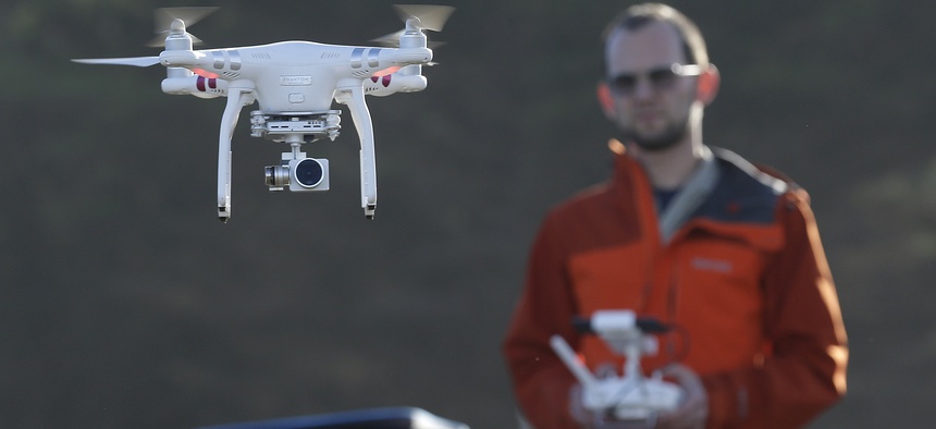 In this Thursday, Jan. 21, 2016 photo, Trent Lukaczyk, an unmanned aerial vehicle (UAV) engineer who builds and flies drones to monitor changes in the ocean environment, controls a DJI Phantom 3 Advanced drone to take photos and videos over the coastline