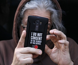 A man holds up his phone during a rally in support of data privacy outside the Apple store Tuesday, Feb. 23, 2016, in San Francisco. A man holds up his phone during a rally in support of data privacy outside the Apple store Tuesday, Feb. 23, 2016, in San Francisco.