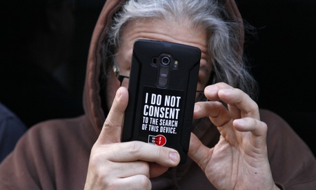 A man holds up his phone during a rally in support of data privacy outside the Apple store Tuesday, Feb. 23, 2016, in San Francisco. A man holds up his phone during a rally in support of data privacy outside the Apple store Tuesday, Feb. 23, 2016, in San Francisco.