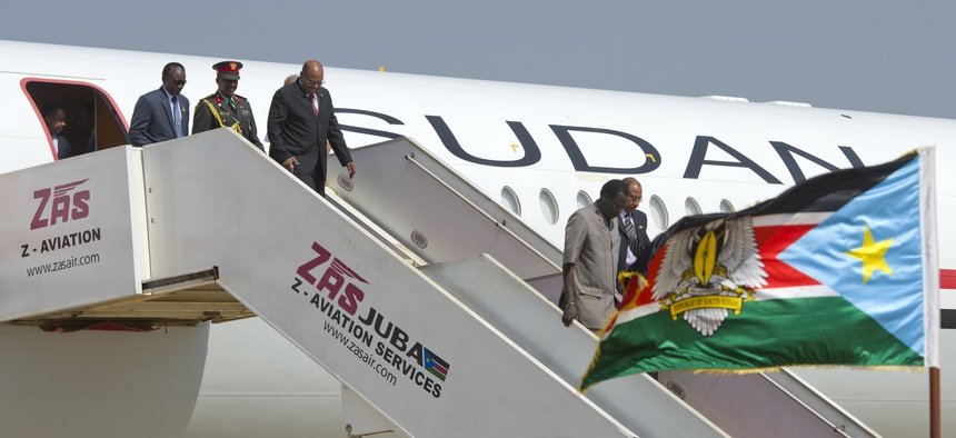 Sudan's President Omar al-Bashir, 3rd left, arrives at the airport ahead of meetings with South Sudan's President Salva Kiir, in the capital Juba, South Sudan Monday, Jan. 6, 2014.