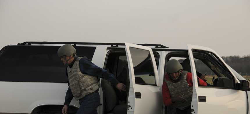 Two civilians rehearse exiting a vehicle under attack at Muscatatuck Training Range, an extension of Camp Atterbury Joint Maneuver Training Center in Edinburgh, Ind., Nov. 7, 2012.