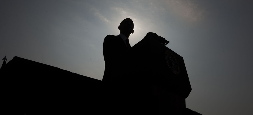 President Barack Obama is silhouetted as he speaks on stage at the Pentagon Memorial, Wednesday, Sept. 11, 2013, in Washington, to mark the 12th anniversary of the 9/11 attacks.