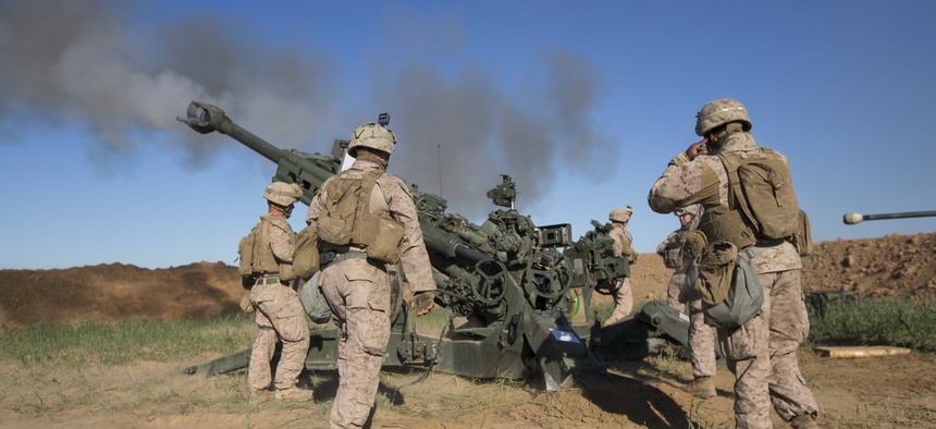 U.S. Marines with Task Force Spartan, 26th Marine Expeditionary Unit (MEU), on Fire Base Bell, Iraq, fire an M777A2 Howitzer at an ISIS infiltration route March 18, 2016.