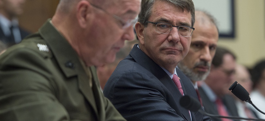 Defense Secretary Ash Carter listens as chairman of the Joint Chiefs of Staff Gen. Joseph Dunford testifies before the House Armed Services Committee on March 22, 2016.