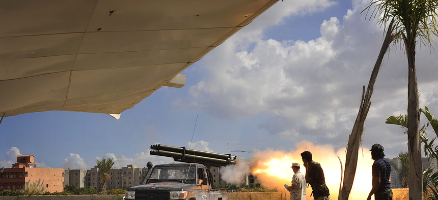 Libyan revolutionary fighters launch a missile towards pro-Gadhafi forces in downtown Sirte, Libya, Friday, Oct. 14, 2011.