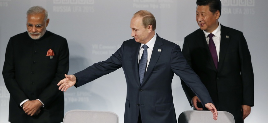 Russian President Vladimir Putin, center, welcomes Indian Prime Minister Narendra Modi, left, and Chinese President Xi Jinping prior signing ceremony at the BRICS Summit in Ufa, Russia, Thursday, July 9, 2015.