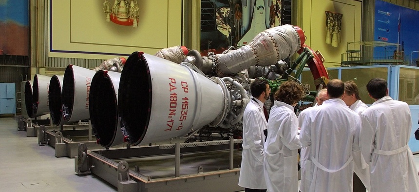 Energomash company employees stand near RD-180 engines prepared for shipment to the United States in a shop at the Energomash, leading Russian rocket engine company, in Moscow, June 6, 2002.
