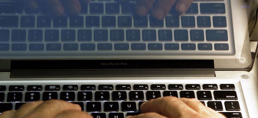 In this Feb. 27, 2013, file photo illustration, hands type on a computer keyboard in Los Angeles.