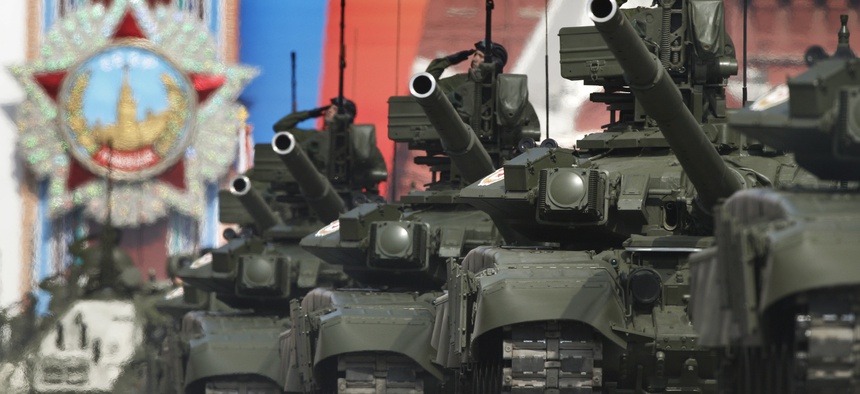 Russian tanks T-90 drive through the Red Square during the Victory Day Parade, which commemorates the 1945 defeat of Nazi Germany in Moscow, Russia, Monday, May 9, 2011, with a display depicting the Order of the Victory in the background.