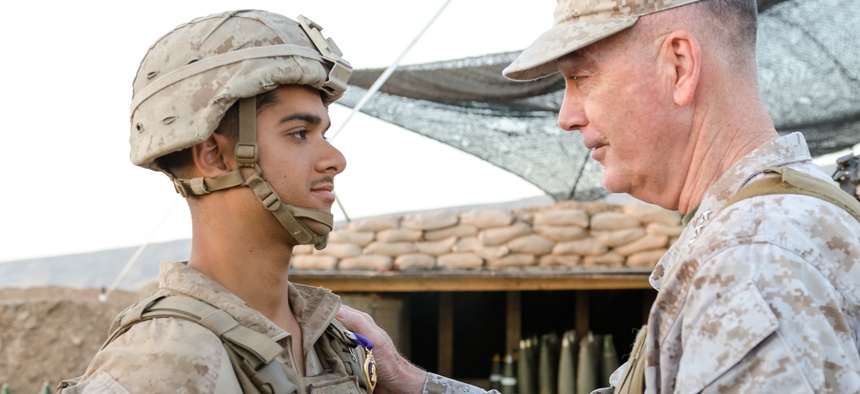 On April 22, Chairman of the Joint Chiefs of Staff Gen. Joseph Dunford presents U.S. Marine Lance Cpl. Javier A. Suarezmontalvo, with a Purple Heart for injuries sustained on March 19 at Kara Soar Base, Makhmur, Iraq.